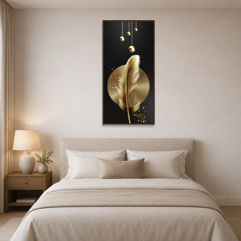 Bedroom wall showcasing a feather art print with gold accents, next to a bedside lamp.