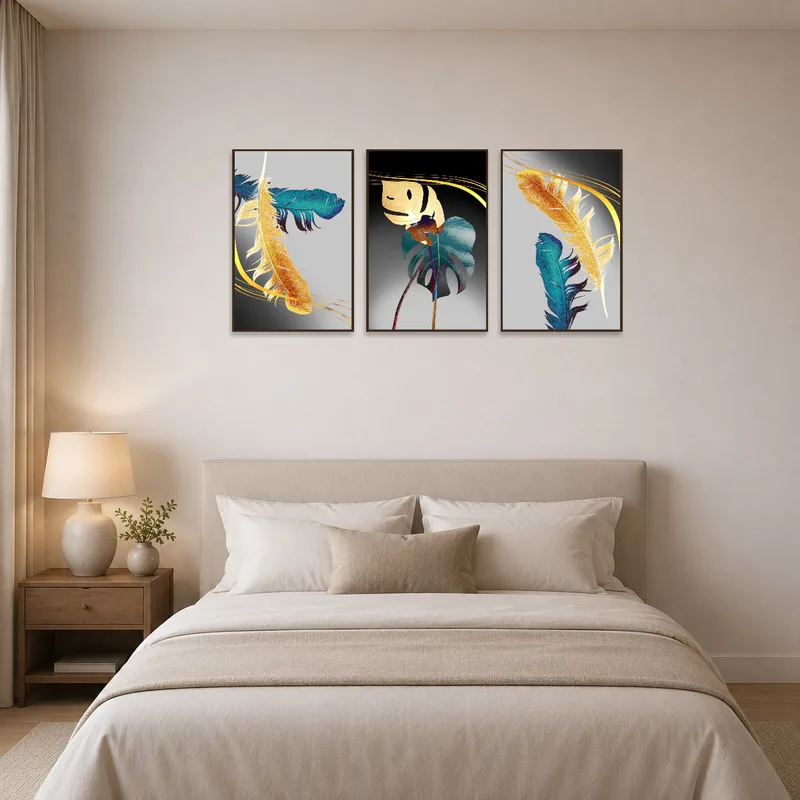 A bedroom wall is tastefully enhanced by the feather and leaves triptych art set.