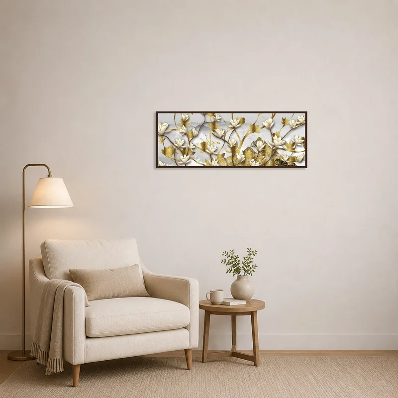 Reading corner adorned with an elegant floral gold and white art print beside a comfy chair.