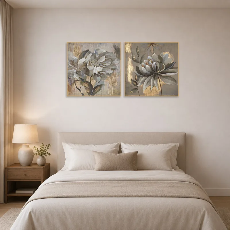 Pair of floral prints with gold accents in a tranquil bedroom.