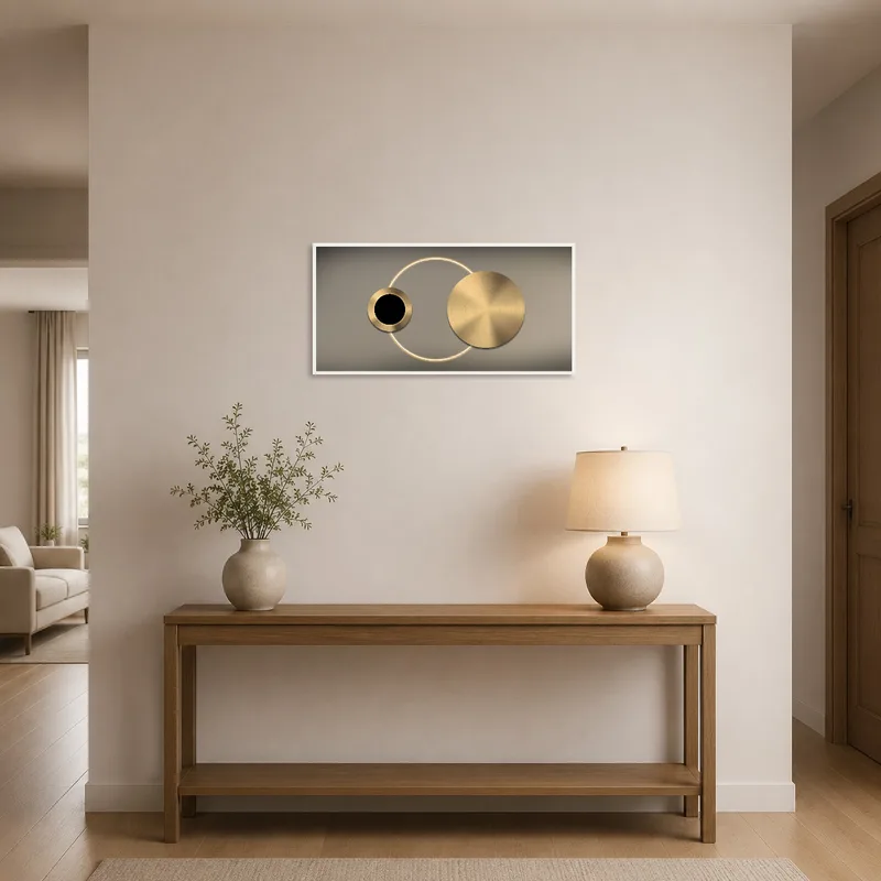 Stylish gold circle art greets guests in a modern entrance hall.