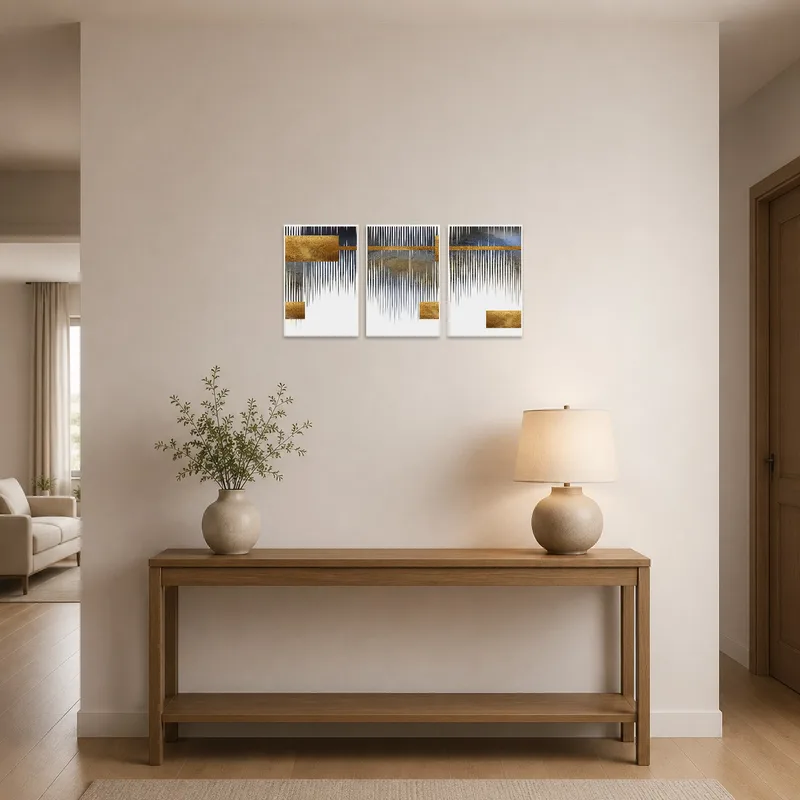 Gold and grey geometric triptych enhances the entrance hall with an elegant touch.