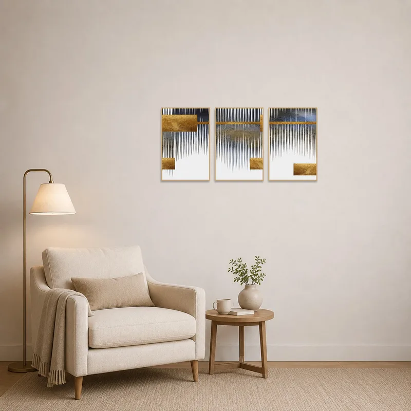 Reading corner adorned with a geometric triptych in elegant gold and grey hues.