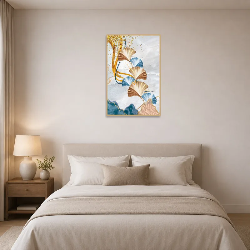 Ginkgo leaves art with gold tones creating a serene atmosphere above a bed with white linens.