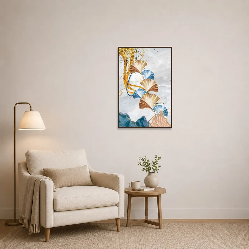 Ginkgo leaves artwork with gold detailing adding charm to a reading corner with a comfy chair.