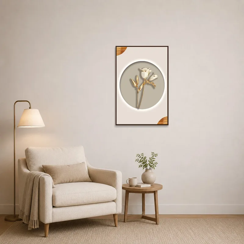 Artwork of gold and beige flowers next to a cozy chair in a reading corner.