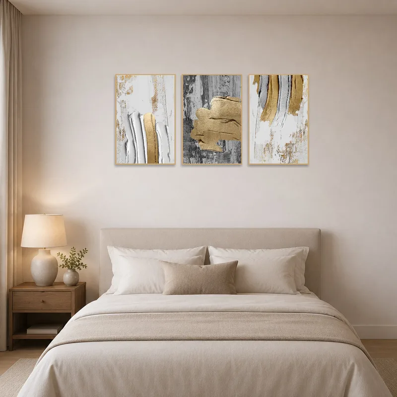 Gold and gray abstract triptych set completes a serene bedroom.