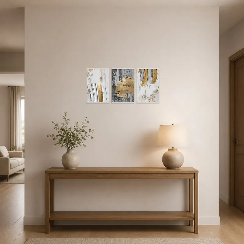 Elegant gold and gray triptych set in a chic entrance hall.