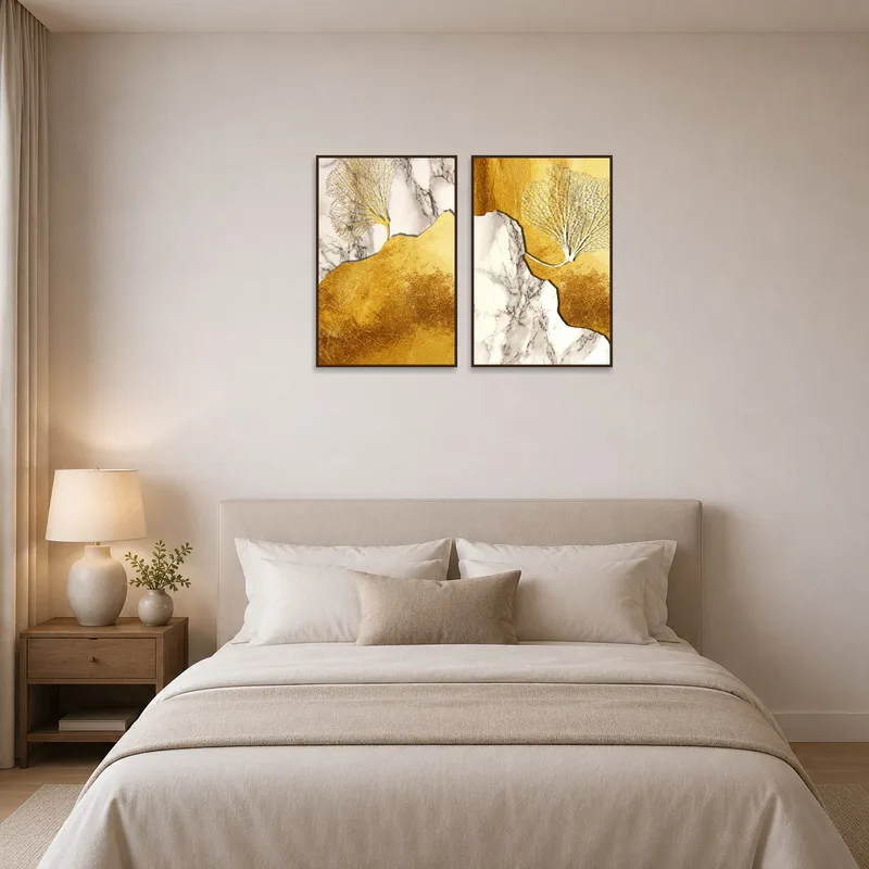 Elegant art set with gold and marble touches in a bedroom.
