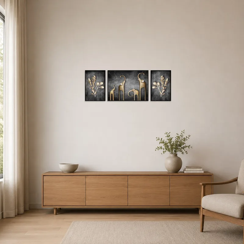 Sleek gold botanical and elephant triptych on a minimalist white wall.