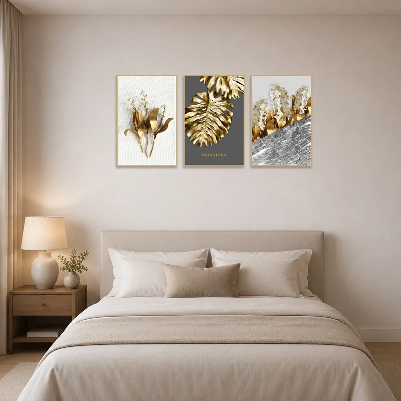 Serene bedroom scene with gold botanical triptych above a plush headboard.