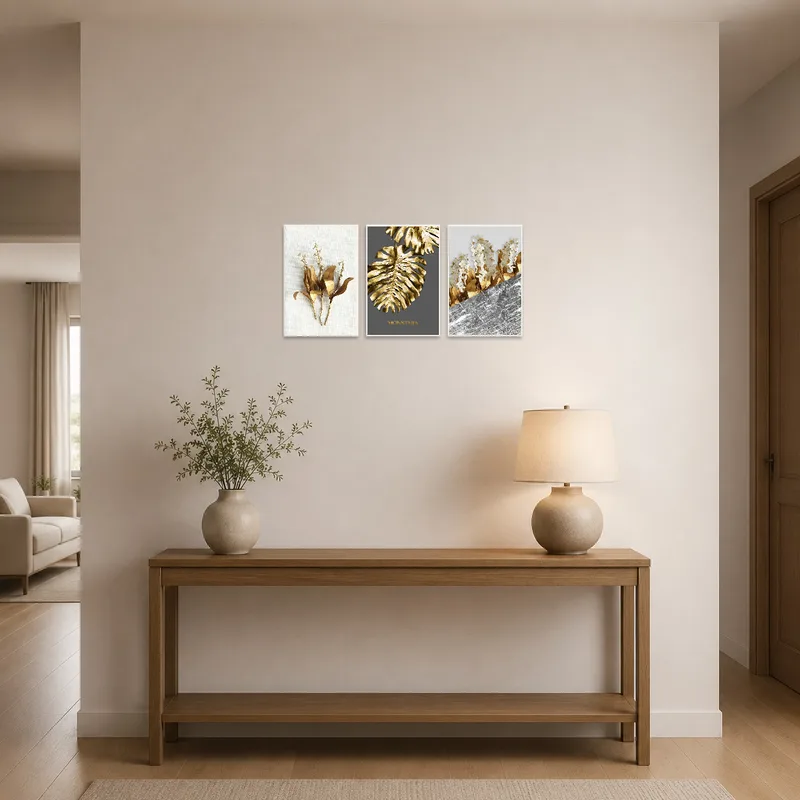 Elegant gold botanical triptych enhancing an entrance hall's welcoming vibe.