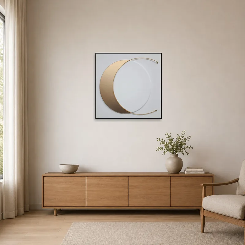 Gold crescent art on a white wall in a minimalist space.