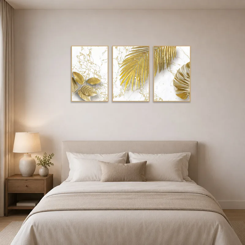 Graceful gold leaf artwork set against a marble background in a serene bedroom.