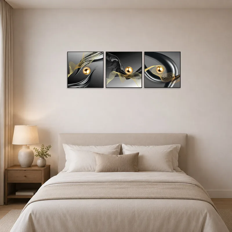 Triptych of abstract golden art enhances bedroom serenity.