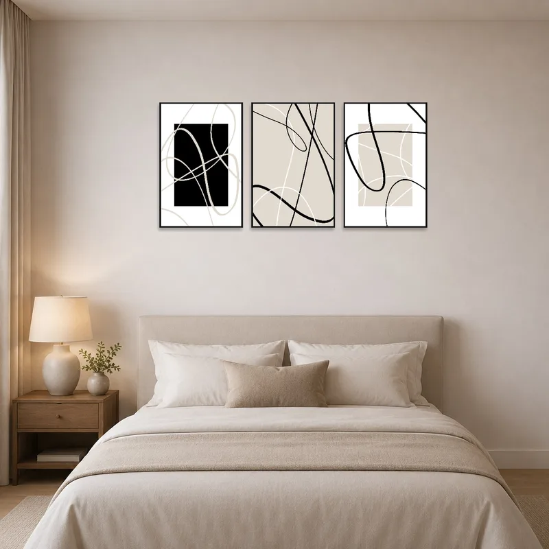 Elegant minimalist abstract line art triptych on a bedroom wall over a sleek headboard.