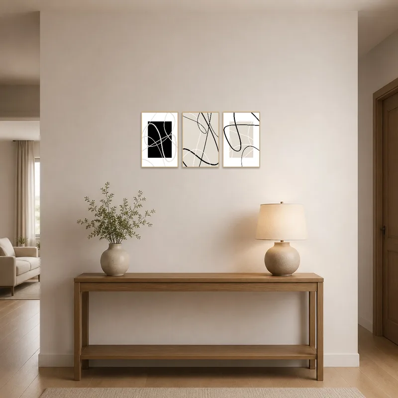 Elegant minimalist abstract line art triptych displayed in a bright entrance hall.