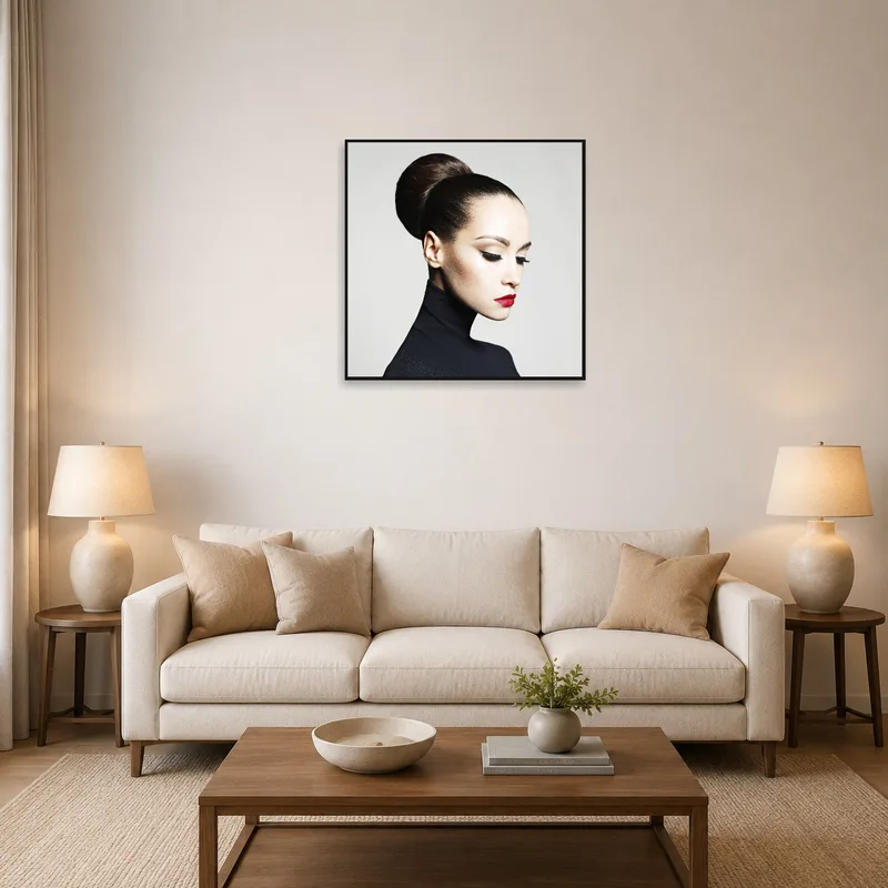 A portrait with red lips hangs above a cozy living-room sofa.