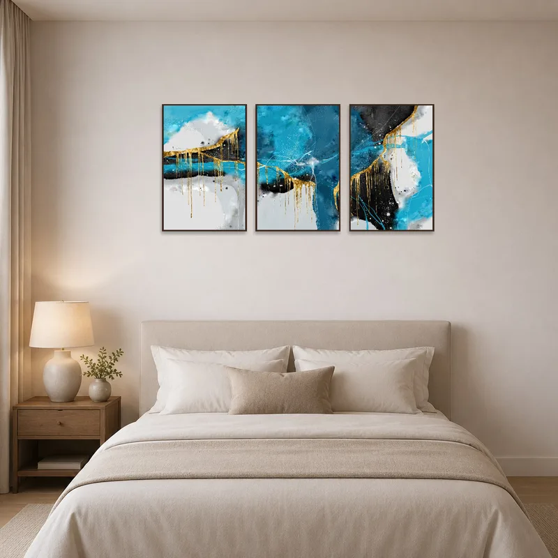 Elegant triptych artwork with blue and gold tones in a serene bedroom.