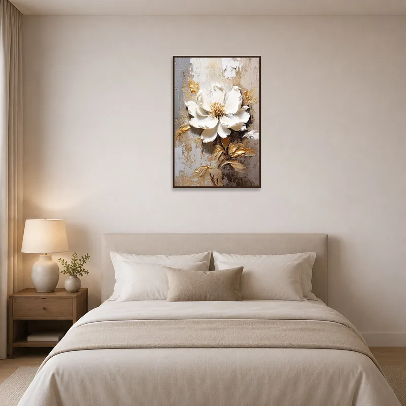 White and gold floral art piece creates a tranquil ambiance above a bed.
