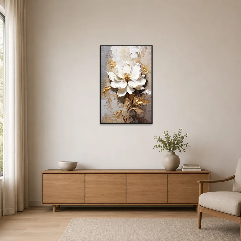 The white bloom in gold stands out on a stark white wall in a minimalist space.