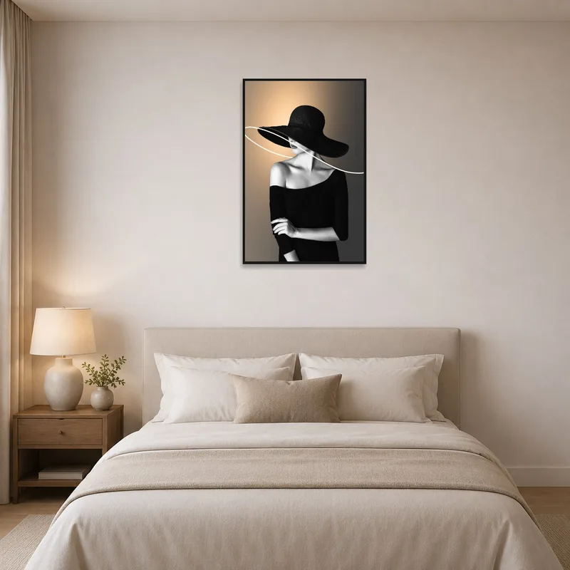 Bedroom displaying elegant woman in hat artwork in monochrome.