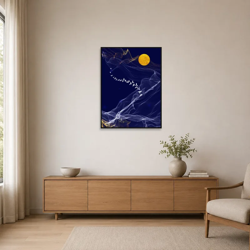 Art print with a bird silhouette against the moon on a simple, white wall.