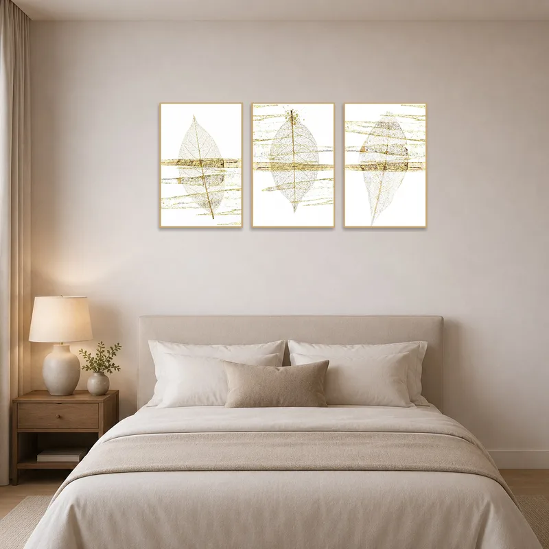 Ethereal Leaf & Gold Abstract Triptych Set adding sophistication to a tranquil bedroom with soft lighting.