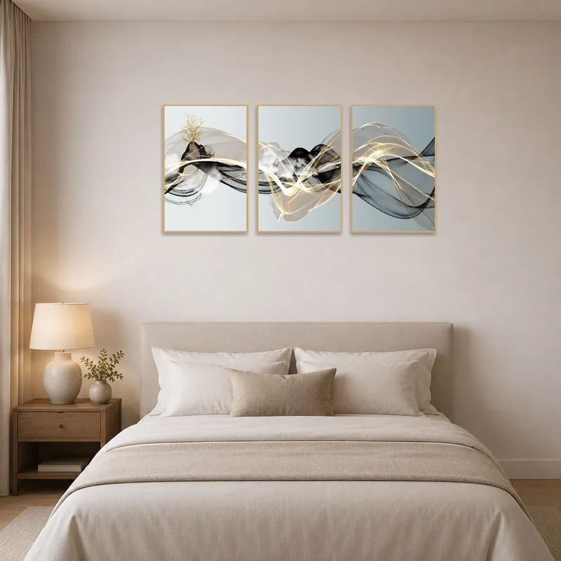 Gold-accented triptych enhances the calm ambiance of a bedroom.