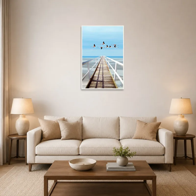 Flamingos over Ocean Pier artwork in a living room above a modern sofa.