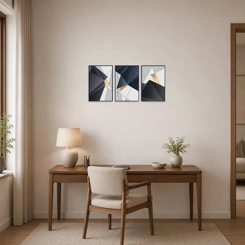 A geometric abstract gold and grey print set on the wall near a desk in the home office.