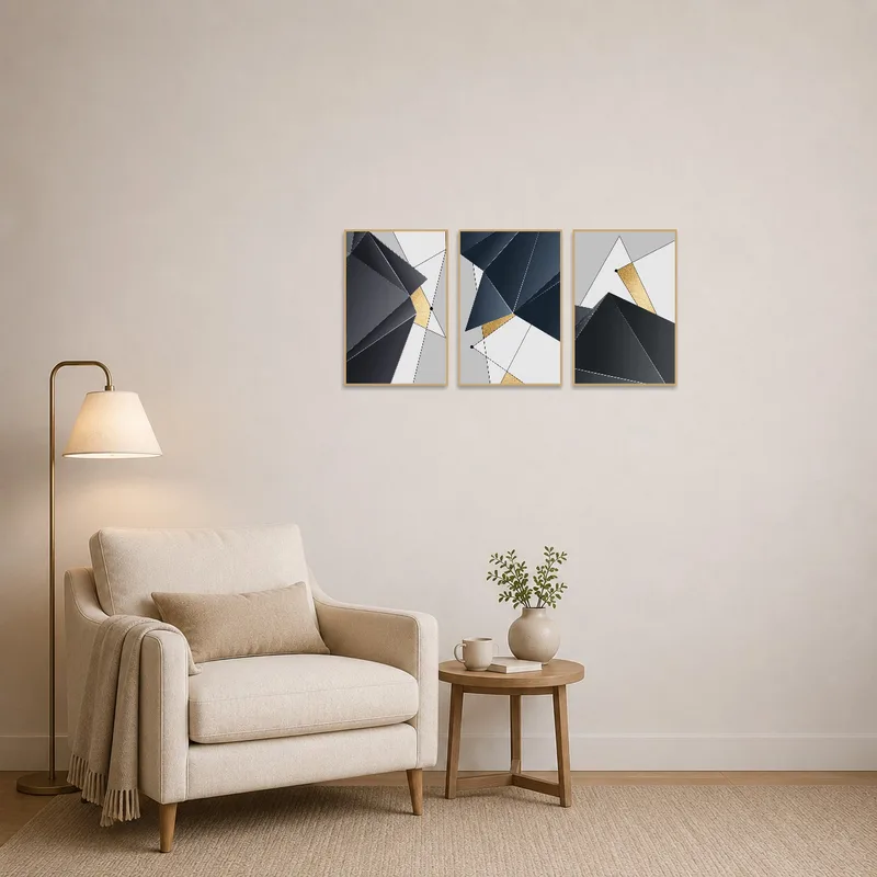 A geometric abstract gold and grey print next to a cozy chair and lamp in the reading corner.