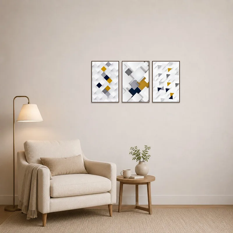 Geometric abstract triptych in white and gold enhancing a cozy reading corner.