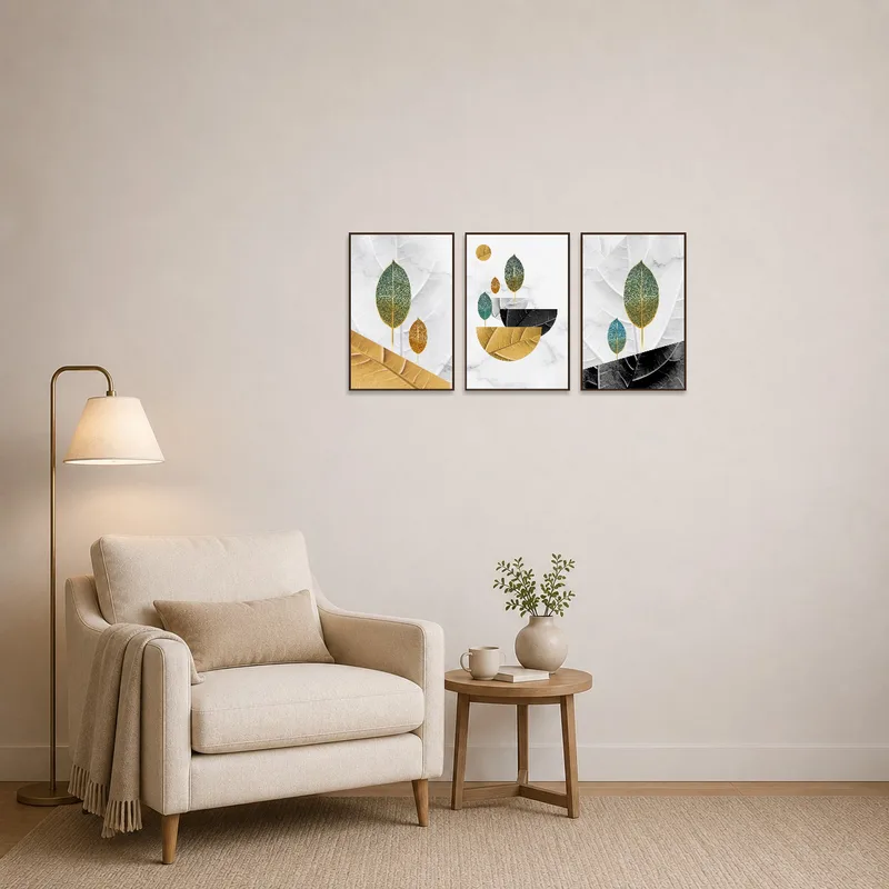Triptych with leaf accents brightens a cozy reading corner filled with books and a chair.
