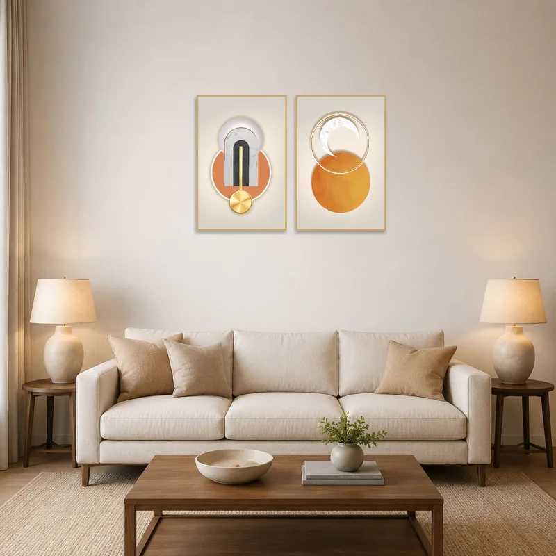 Set of two geometric abstract artworks above a modern sofa in a living room.