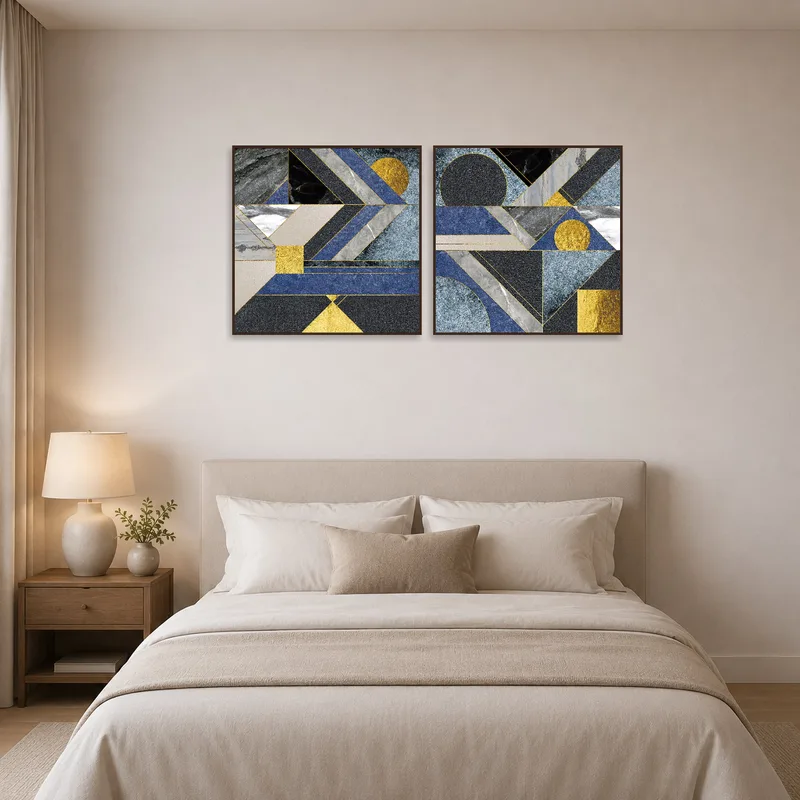 Pair of geometric blue and gold prints above a bedroom headboard.