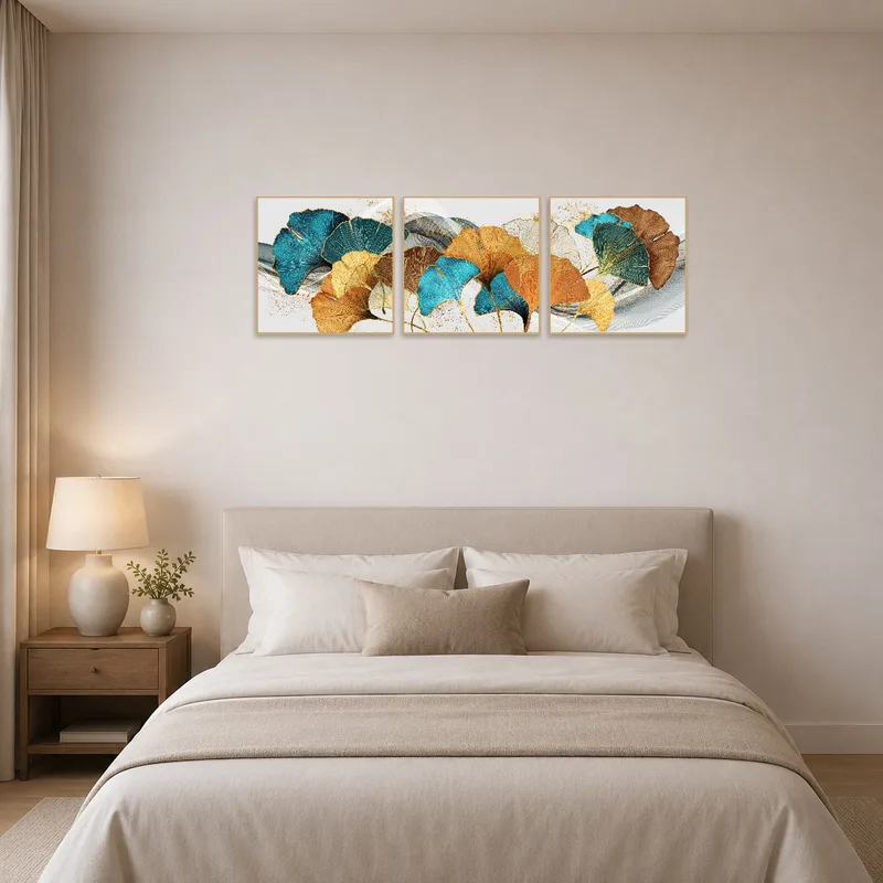 The bedroom wall features a ginkgo leaf triptych in turquoise and gold, enhancing the peacefulness with natural patterns.