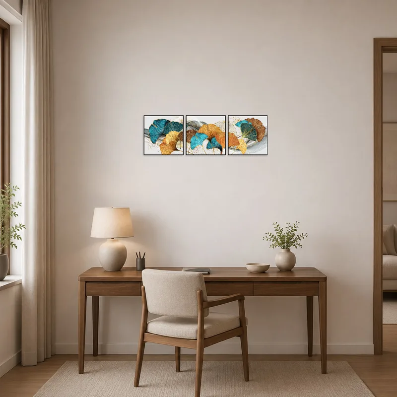 A home office gains inspiration from a turquoise and gold ginkgo leaf triptych, creating a lively yet calming atmosphere.