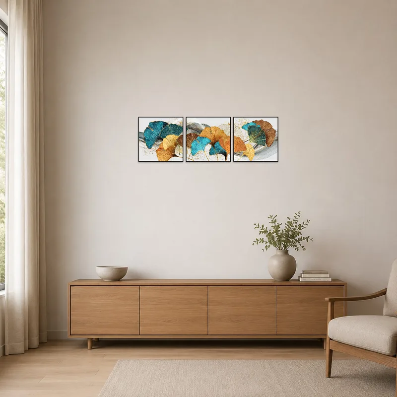 In a minimalist space, the ginkgo leaf triptych in turquoise and gold provides a stylish focal point on a white wall.