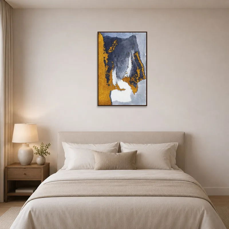 Gold and gray abstract art adding luxury to a serene bedroom.