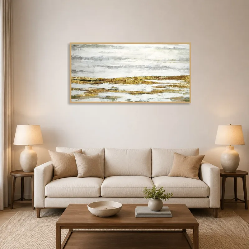 Abstract landscape art in gold and gray adds elegance to a living room setting.