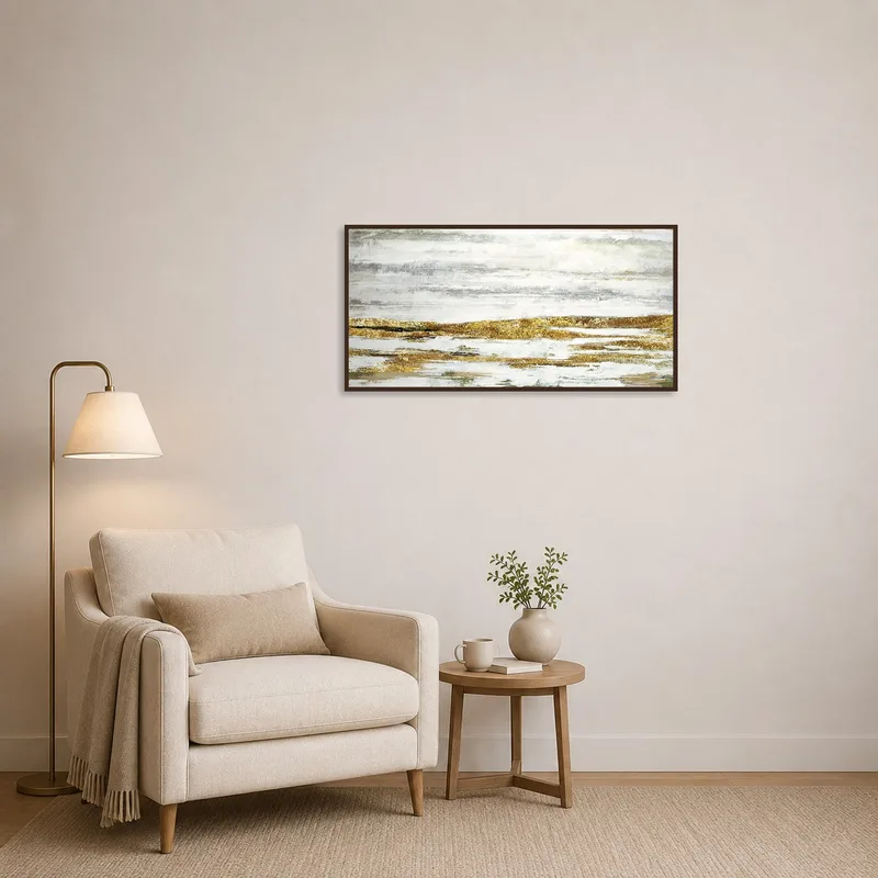 Reading corner enhanced by the serene tones of gold and gray landscape art.
