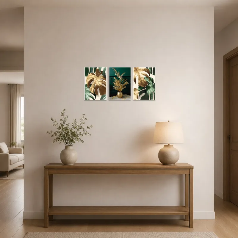 Entrance hall adorned with botanical triptych featuring gold and green leaves.