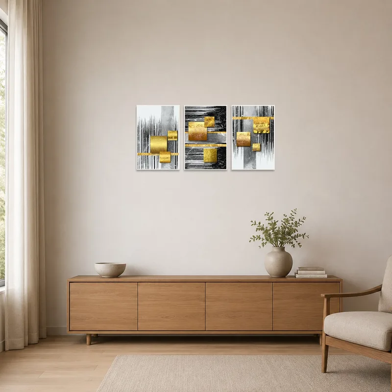 Sleek gold and silver geometric triptych on a plain white wall.
