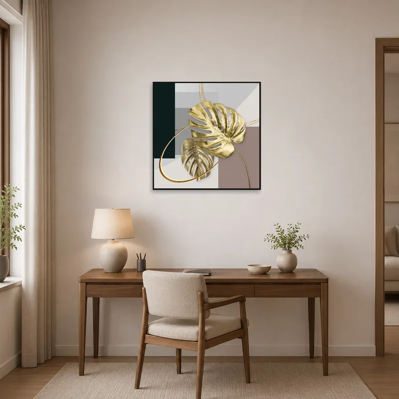 Home office with gold monstera leaves and geometric background on display.