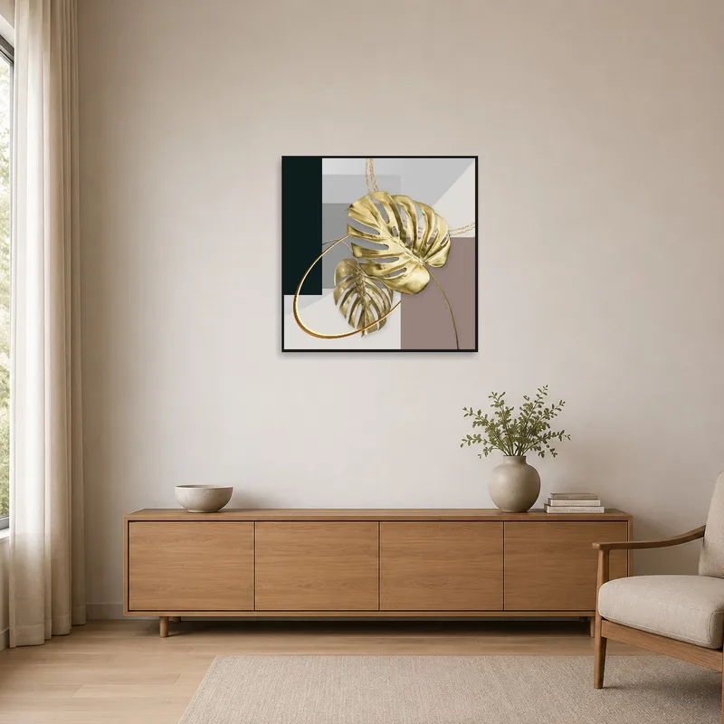 Gold monstera leaves and geometric shapes in a minimalist setting.