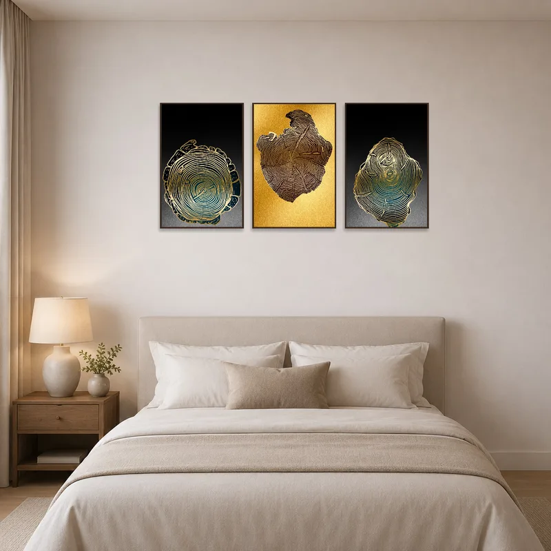 Gold Tree Rings Abstract Triptych adorns the wall above a king-sized bed with soft bedding.