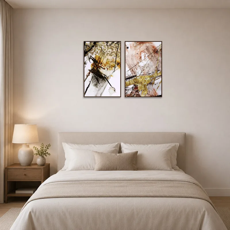 Sophisticated set of gold abstract pieces above the headboard in a bedroom.