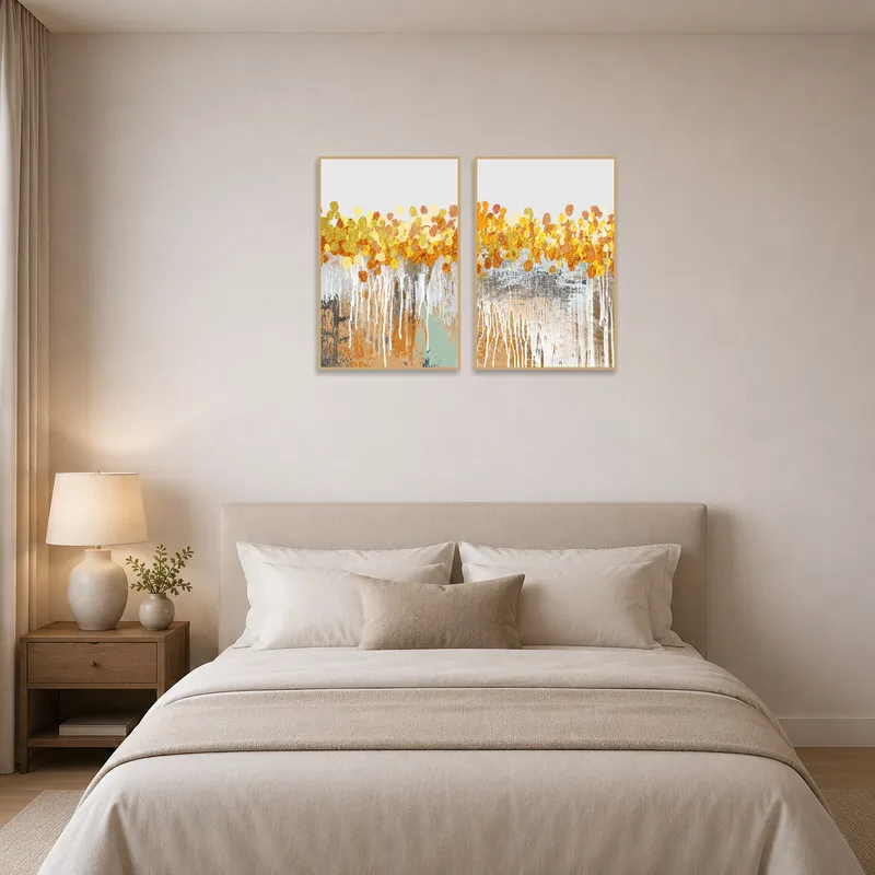 Golden abstract drip art set adds warmth to a serene bedroom.