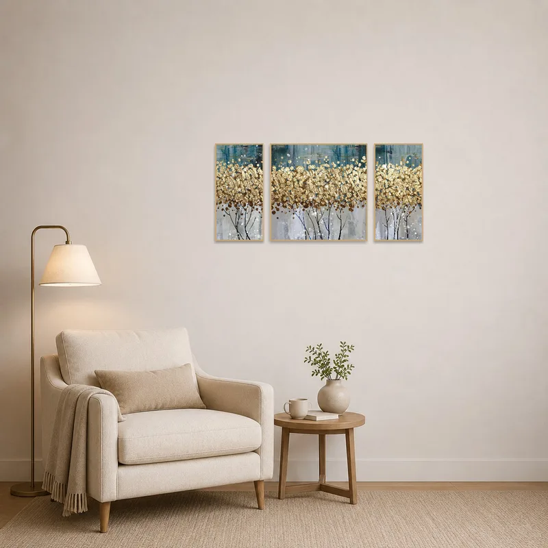 A cozy reading corner highlighted by a textured golden abstract triptych.